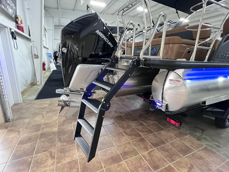 Slide: The Image of 2025 Harris Solstice 250 boat with Mercury engine and ladder in showroom. - 35