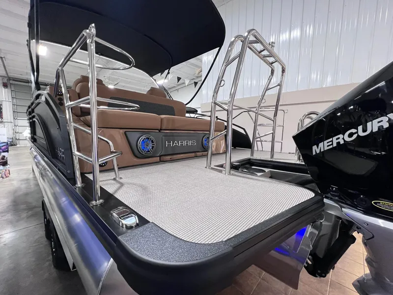 Slide: The Image of 2025 Harris Solstice 250 pontoon boat with Mercury engine, sleek design, and modern features. - 36