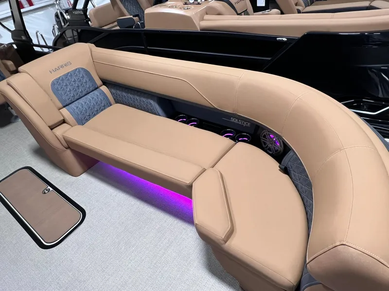 Slide: The Image of 2025 Harris Solstice 250 boat interior with beige seating and ambient purple lighting. - 7