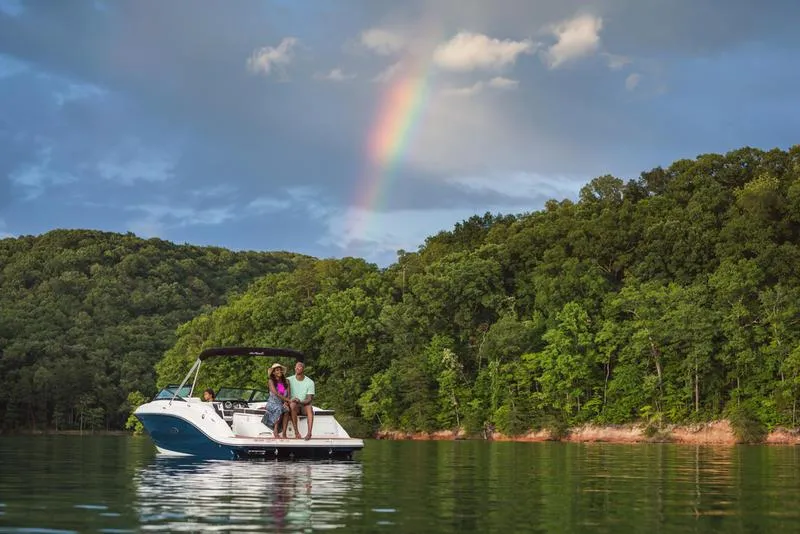 Slide: The Image of 2024 Sea Ray SPX 230 boat on a lake with a rainbow and lush forest backdrop. - 5