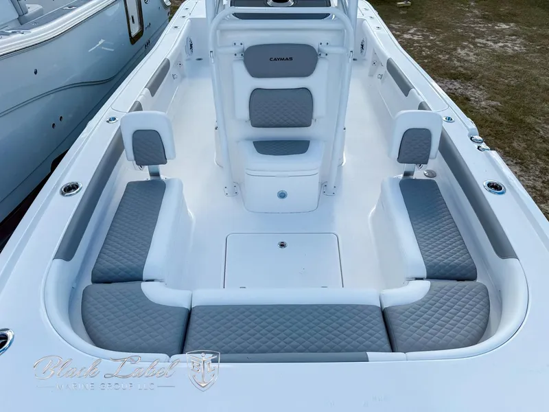 Slide: The Image of 2025 Caymas 281 HB boat interior with gray cushioned seating and white deck. - 11