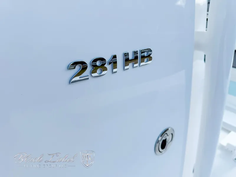 Slide: The Image of 2025 Caymas 281 HB boat model emblem on white surface. - 12