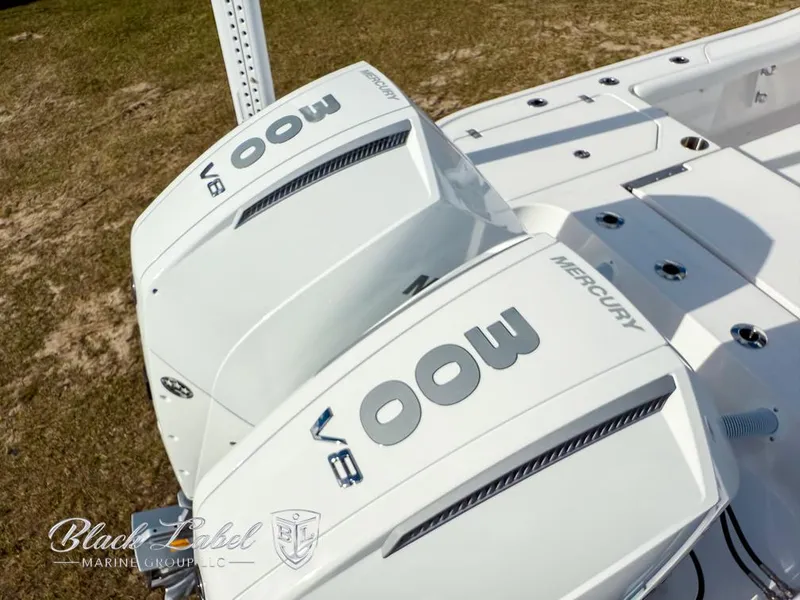 Slide: The Image of 2025 Caymas 281 HB boat with twin Mercury 300 V8 engines, displayed outdoors. - 29