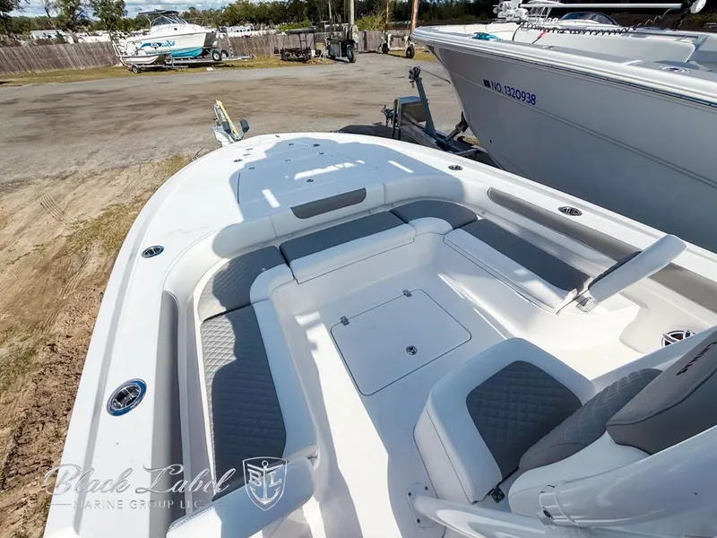 Slide: The Image of 2025 Caymas 281 HB boat interior with cushioned seating and storage compartments. - 6