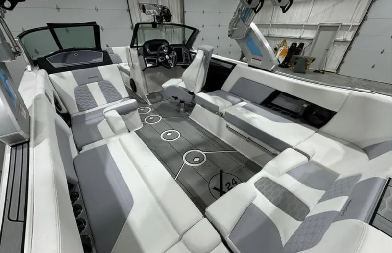 Slide: The Image of 2024 MasterCraft X24 SurfStar badge on glittering blue surface. - 11