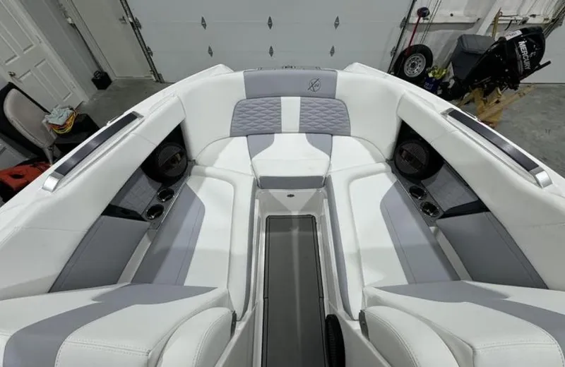 Slide: The Image of 2024 MasterCraft X24 boat on trailer, rear view in indoor setting. - 13