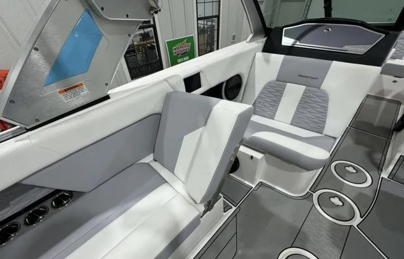 Slide: The Image of 2024 MasterCraft X24 boat displayed indoors, showcasing sleek design and modern features. - 15