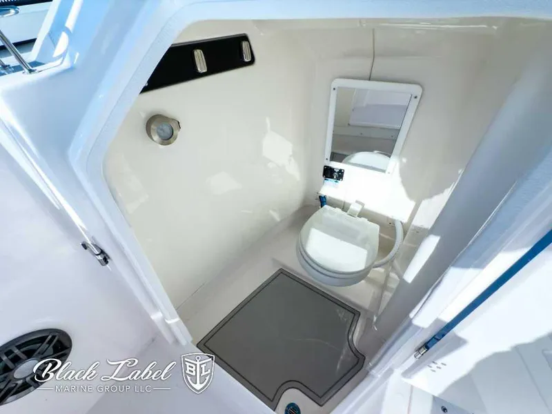 Slide: The Image of 2025 Sea Fox 268 Traveler Dual Console boat interior with compact marine toilet. - 12