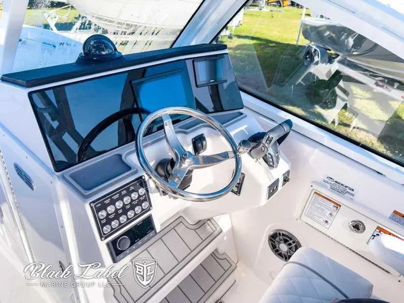 Slide: The Image of 2025 Sea Fox 268 Traveler Dual Console boat interior with steering wheel and control panel. - 14