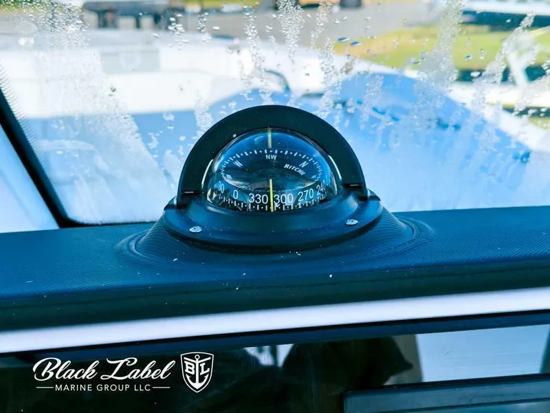 Slide: The Image of Compass on Sea Fox 268 Traveler Dual Console, 2025 model, with Black Label Marine Group logo. - 16