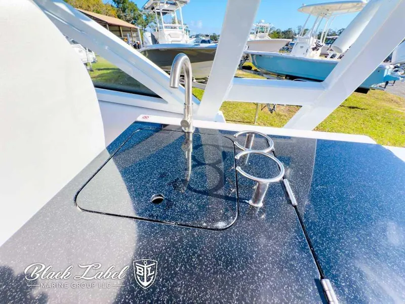 Slide: The Image of 2025 Sea Fox 268 Traveler Dual Console boat sink and cup holders on deck. - 22