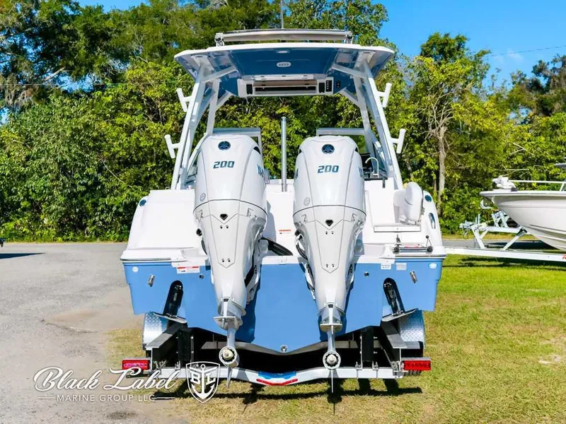 Slide: The Image of 2025 Sea Fox 268 Traveler Dual Console with twin 200 engines, parked outdoors. - 3