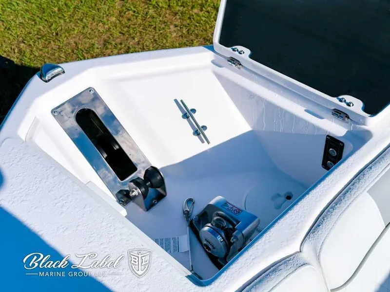 Slide: The Image of Sea Fox 268 Traveler Dual Console 2025 anchor compartment, open lid, sunny day. - 9