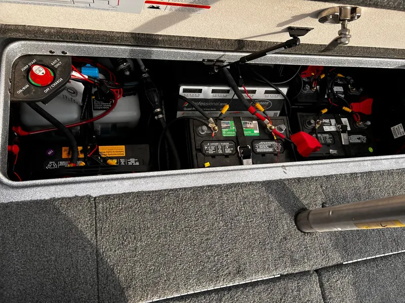 Slide: The Image of 2017 Ranger Z521 Comanche boat battery compartment with multiple batteries and wiring. - 8