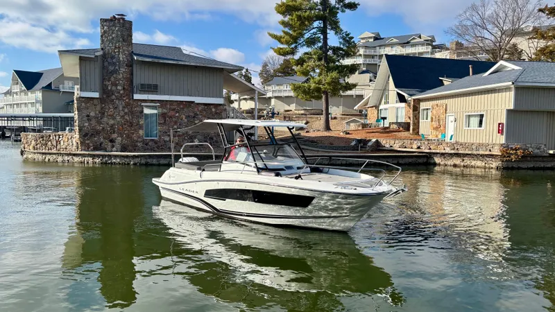 The Image of 2022 Jeanneau Leader 7.5 boat docked near waterfront homes. - 0
