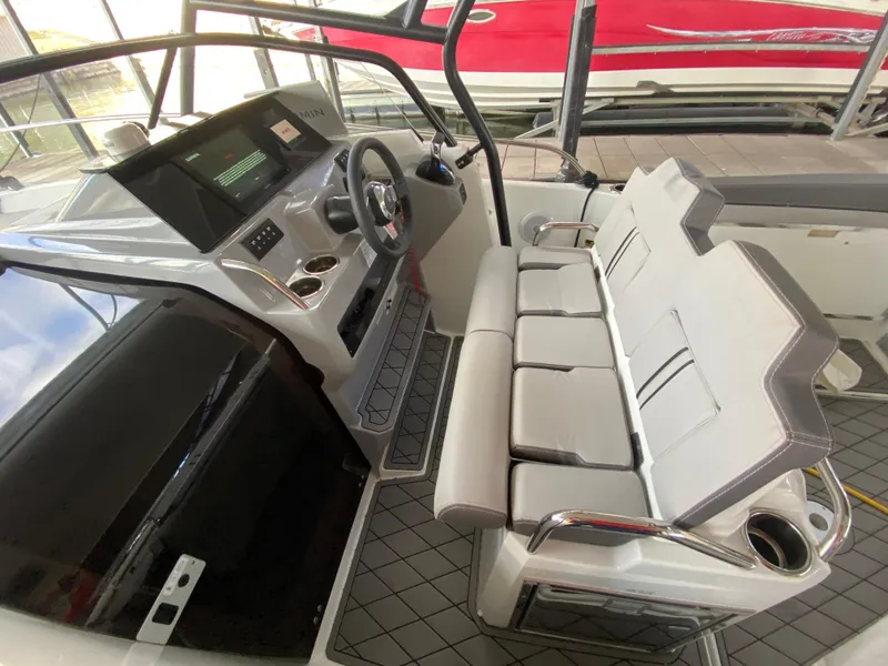 Slide: The Image of Interior of 2022 Jeanneau Leader 7.5 boat with modern seating and steering console. - 10