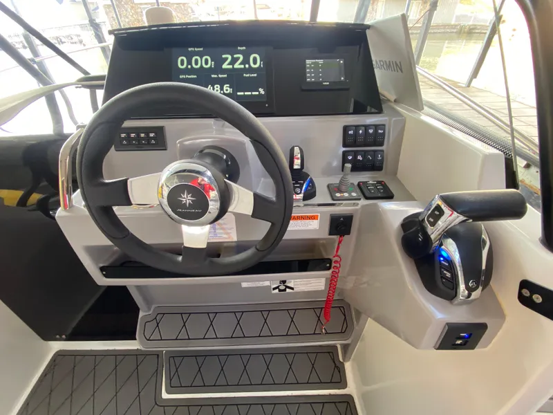 Slide: The Image of 2022 Jeanneau Leader 7.5 cockpit with steering wheel and control panel. - 12