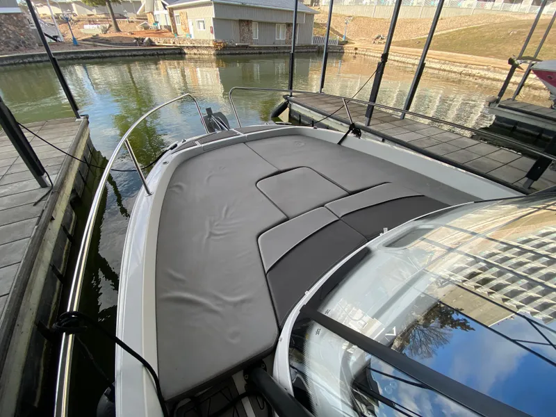 Slide: The Image of 2022 Jeanneau Leader 7.5 boat docked, featuring a spacious sunpad and sleek design. - 16