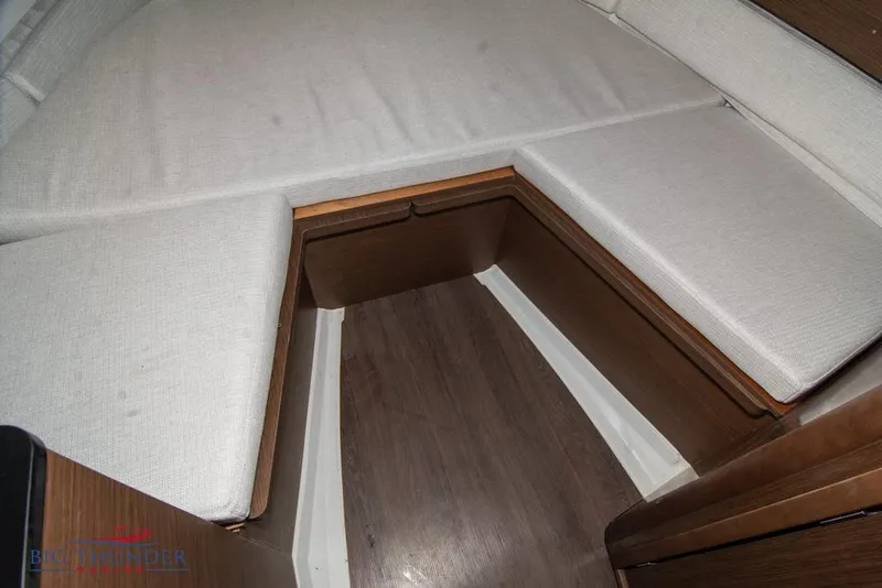 Slide: The Image of Interior cabin of 2022 Jeanneau Leader 7.5 with cushioned seating and wooden flooring. - 19