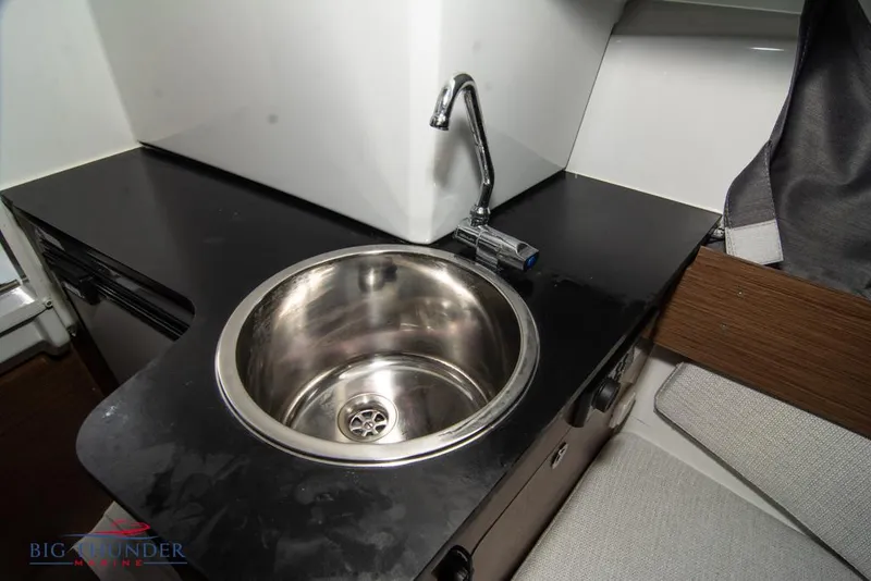 Slide: The Image of 2022 Jeanneau Leader 7.5 boat interior with modern sink and countertop. - 24