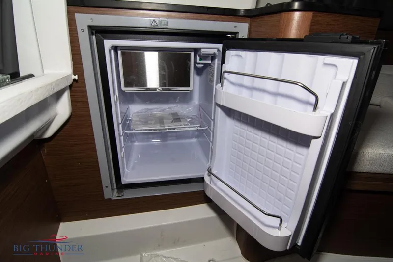Slide: The Image of Open mini fridge inside 2022 Jeanneau Leader 7.5 boat cabin. - 25