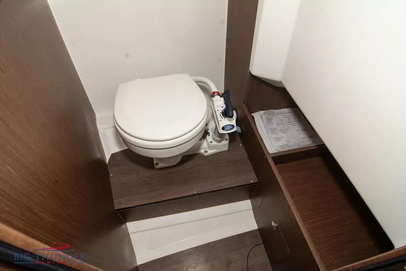 Slide: The Image of 2022 Jeanneau Leader 7.5 boat interior with compact marine toilet. - 27