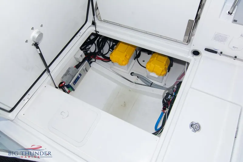 Slide: The Image of Jeanneau Leader 7.5 2022 boat battery compartment with wiring and storage. - 28