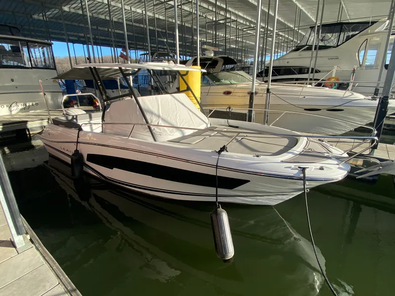 Slide: The Image of 2022 Jeanneau Leader 7.5 boat docked in marina, covered and ready for use. - 30