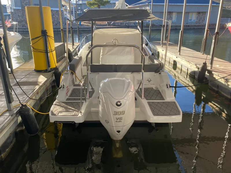 Slide: The Image of 2022 Jeanneau Leader 7.5 boat docked in marina, rear view. - 31