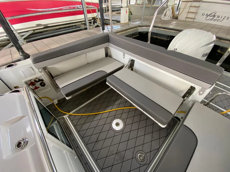 Slide: The Image of 2022 Jeanneau Leader 7.5 boat interior with foldable seating and modern design. - 6