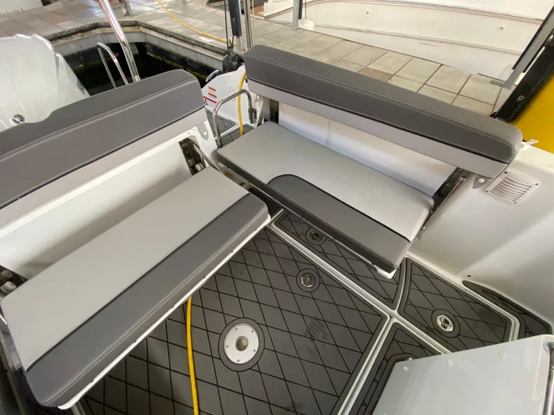 Slide: The Image of 2022 Jeanneau Leader 7.5 boat interior with gray seating and non-slip flooring. - 7