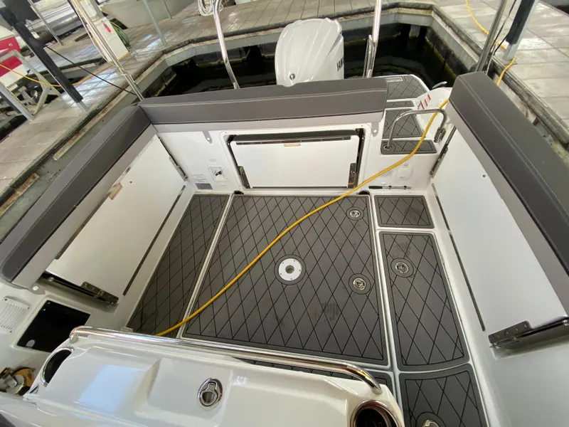 Slide: The Image of 2022 Jeanneau Leader 7.5 boat interior with modern seating and deck design. - 8