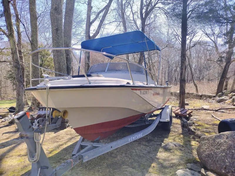 Slide: The Image of 1983 Boston Whaler 25 Revenge boat on trailer, parked in wooded area. - 17