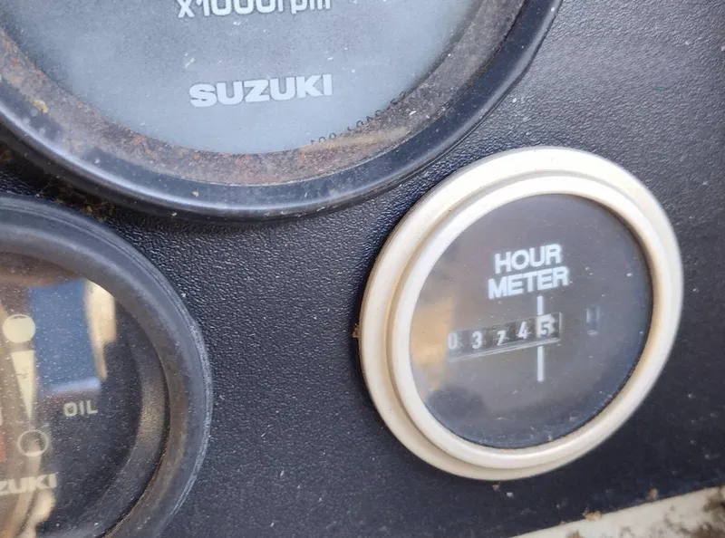 Slide: The Image of Hour meter reading 3745 on 1983 Boston Whaler 25 Revenge dashboard with Suzuki gauges. - 35