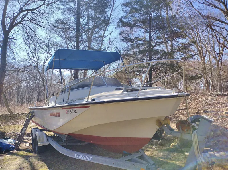 Slide: The Image of 1983 Boston Whaler 25 Revenge boat on trailer, parked outdoors with trees in the background. - 5
