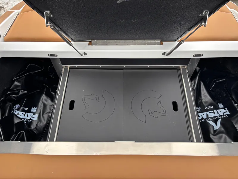 Slide: The Image of Centurion NV213 2025 boat storage compartment with open lid and interior view. - 13