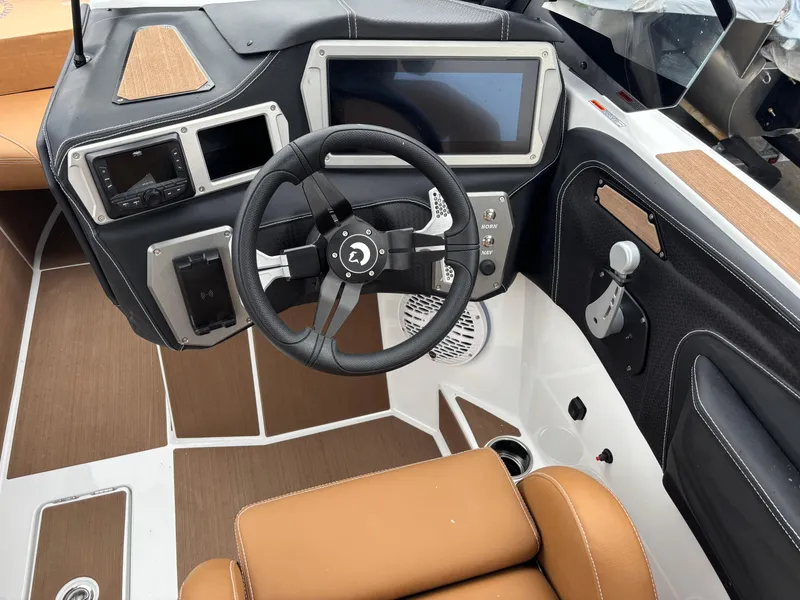 Slide: The Image of 2025 Centurion NV213 boat dashboard with steering wheel and touchscreen display. - 15