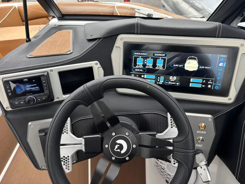 Slide: The Image of Centurion NV213 2025 boat dashboard with advanced digital controls and steering wheel. - 2