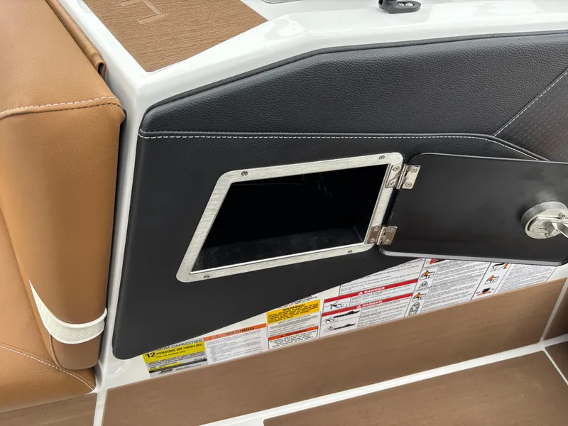 Slide: The Image of Centurion NV213 2025 boat storage compartment with open door and safety labels. - 3