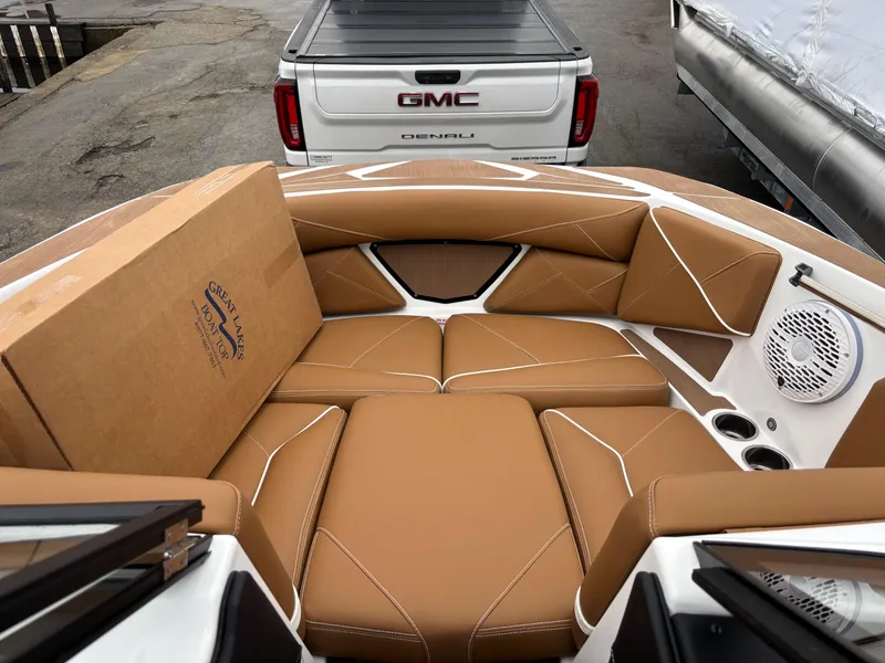Slide: The Image of Centurion NV213 boat interior with tan leather seats, parked near a GMC Denali truck. - 4