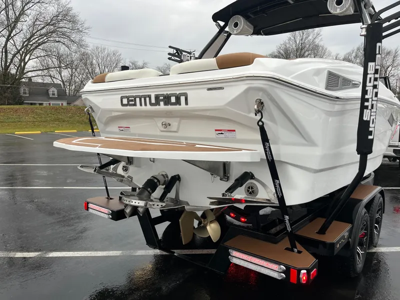Slide: The Image of 2025 Centurion NV213 boat on trailer, rear view, parked on wet pavement. - 8