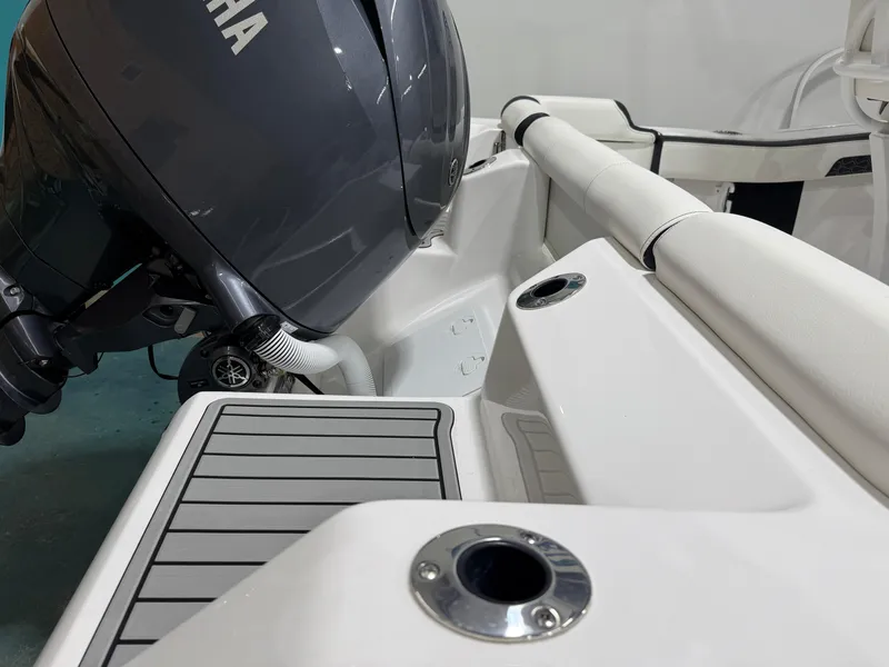 Slide: The Image of 2025 Tidewater 210LXF boat with Yamaha engine, featuring sleek white interior and deck. - 10