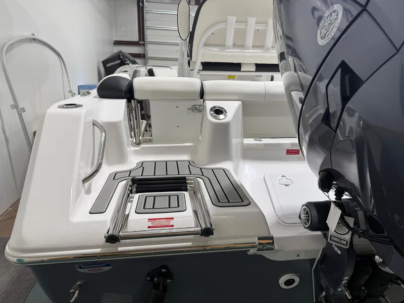 Slide: The Image of 2025 Tidewater 210LXF boat with Yamaha engine, featuring a sleek deck and swim ladder. - 11