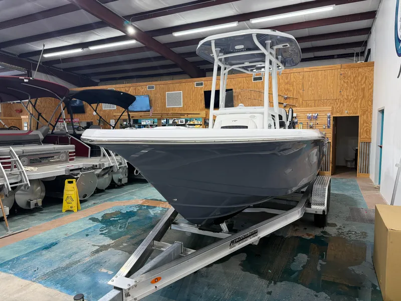 Slide: The Image of 2025 Tidewater 210LXF boat displayed indoors on a trailer. - 12
