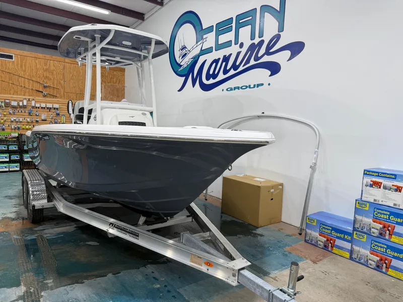 Slide: The Image of 2025 Tidewater 210LXF boat on trailer at Ocean Marine Group showroom. - 13