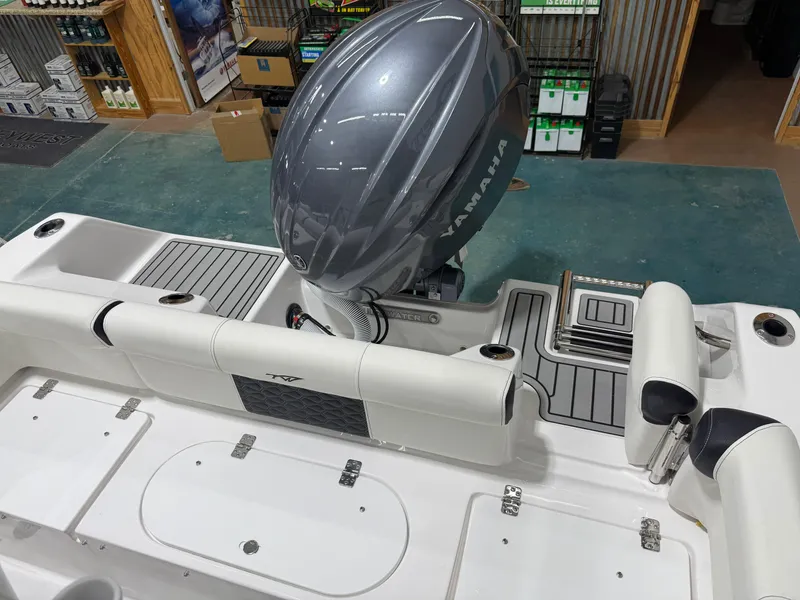 Slide: The Image of 2025 Tidewater 210LXF boat interior with Yamaha engine in showroom. - 15