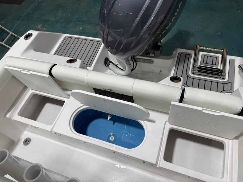 Slide: The Image of 2025 Tidewater 210LXF boat interior with storage compartments and Yamaha engine. - 17