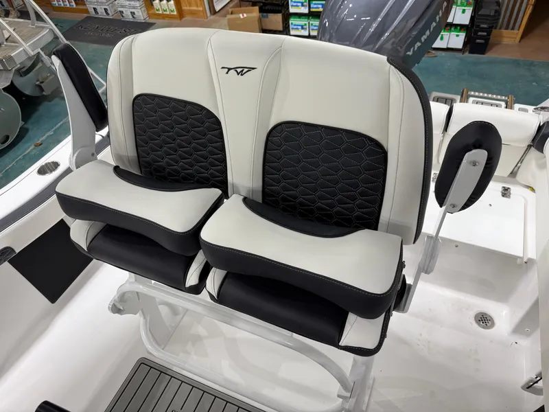 Slide: The Image of 2025 Tidewater 210LXF boat seats with black and white upholstery in a showroom. - 19