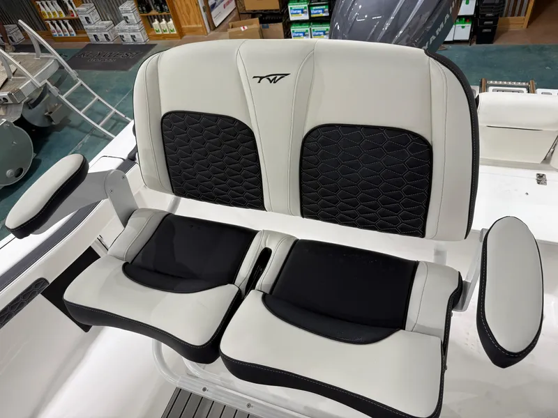 Slide: The Image of 2025 Tidewater 210LXF boat seating with black and white upholstery. - 20