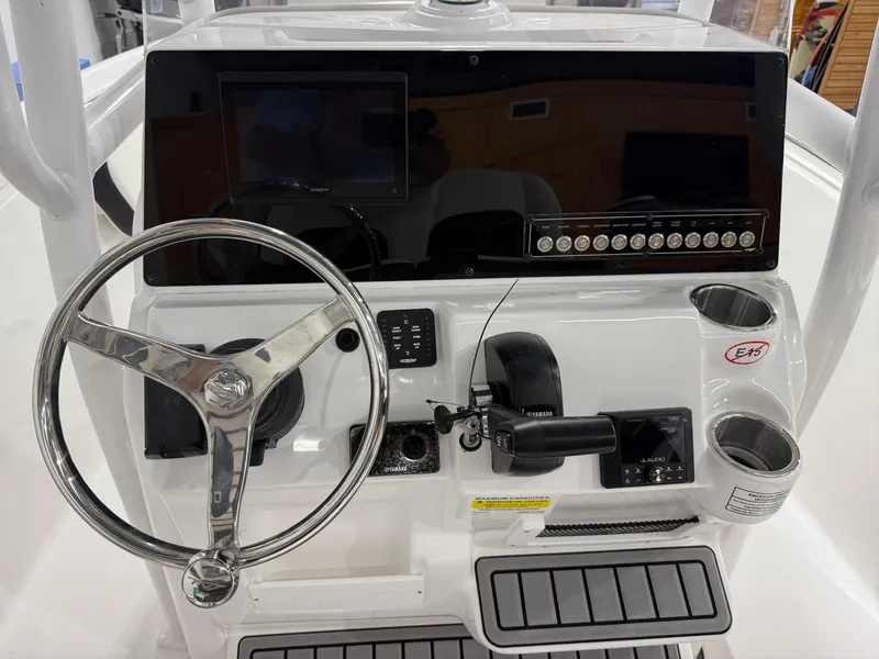 Slide: The Image of 2025 Tidewater 210LXF boat dashboard with steering wheel and control panel. - 22